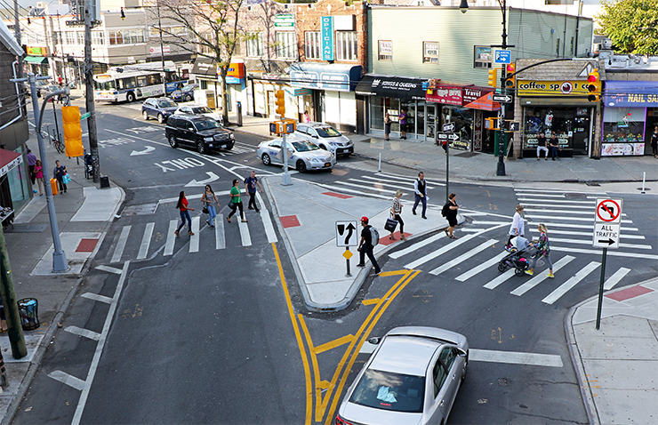 A photograph of a complex intersection on Sheepshead Bay Road in Brooklyn. This intersection received several Vision Zero intervetnions, including turn traffic calming and enhanced crossing.